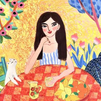 A beautiful young woman enjoys a glass of lemonade with her pet cat on a sunny summer afternoon.